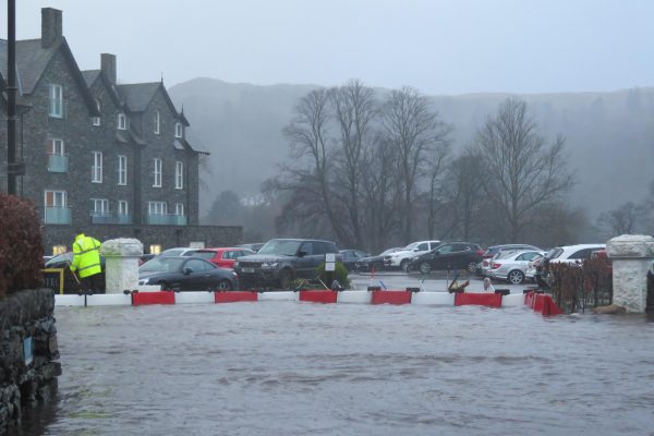 Floodstop barriers diverting fast flowing flood waters Cumbrian Flood Defence Floodstop, flood barriers holding back waters